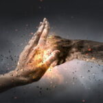 One hand preventing punch attack of another hand